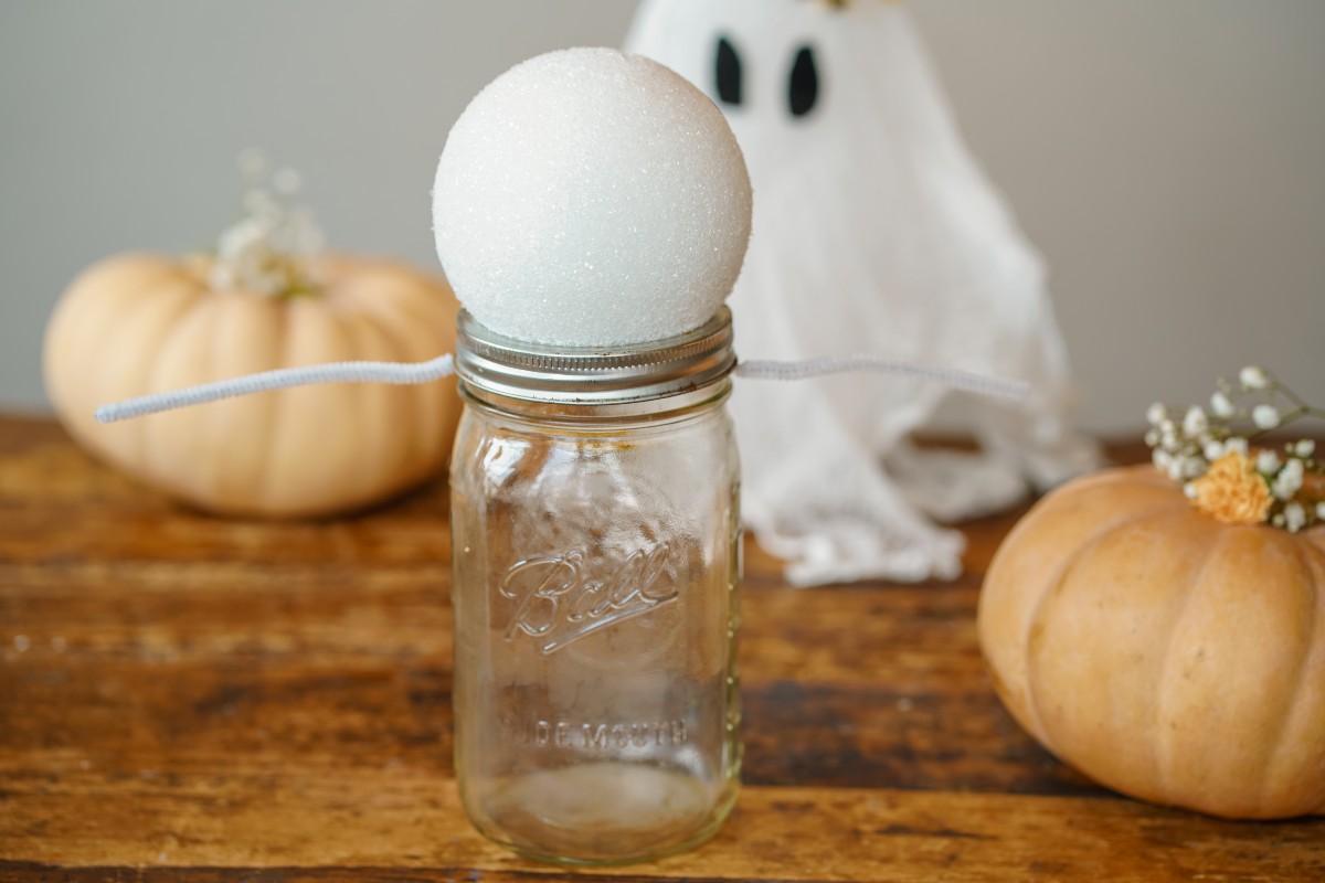 Styrofoam ball sitting on a jar ready to make a cheesecloth ghost