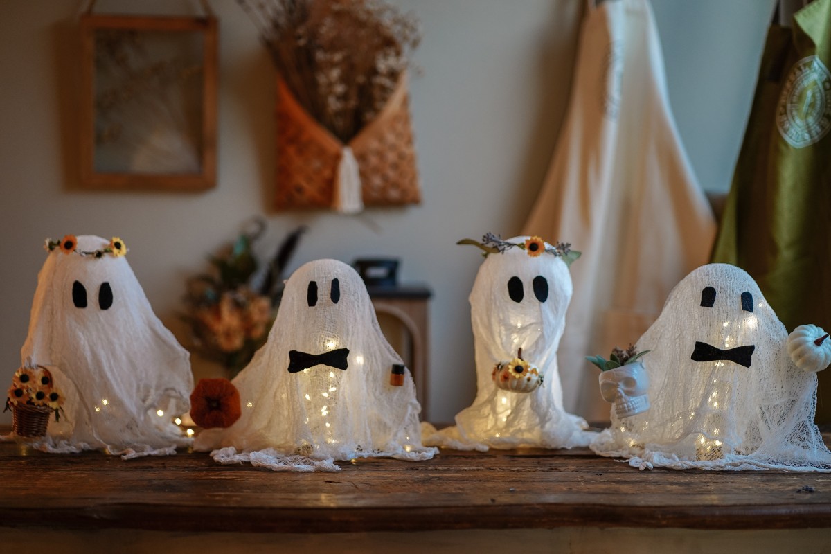 four cheesecloth ghosts standing in a line