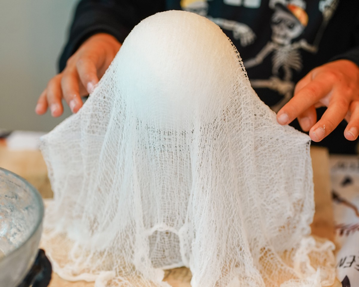 placing cheesecloth over Styrofoam ball