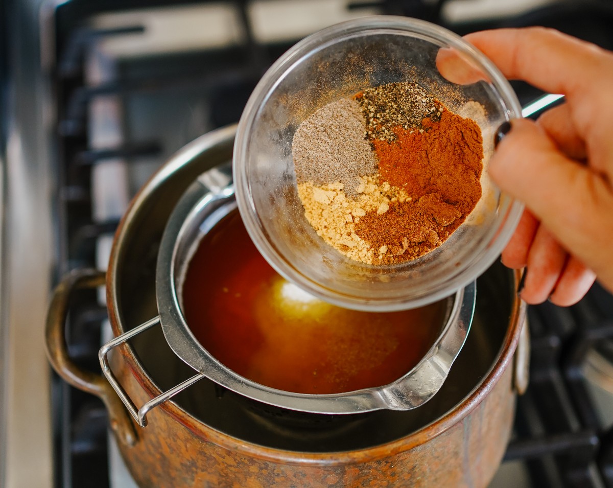 pouring chai spices into mixture
