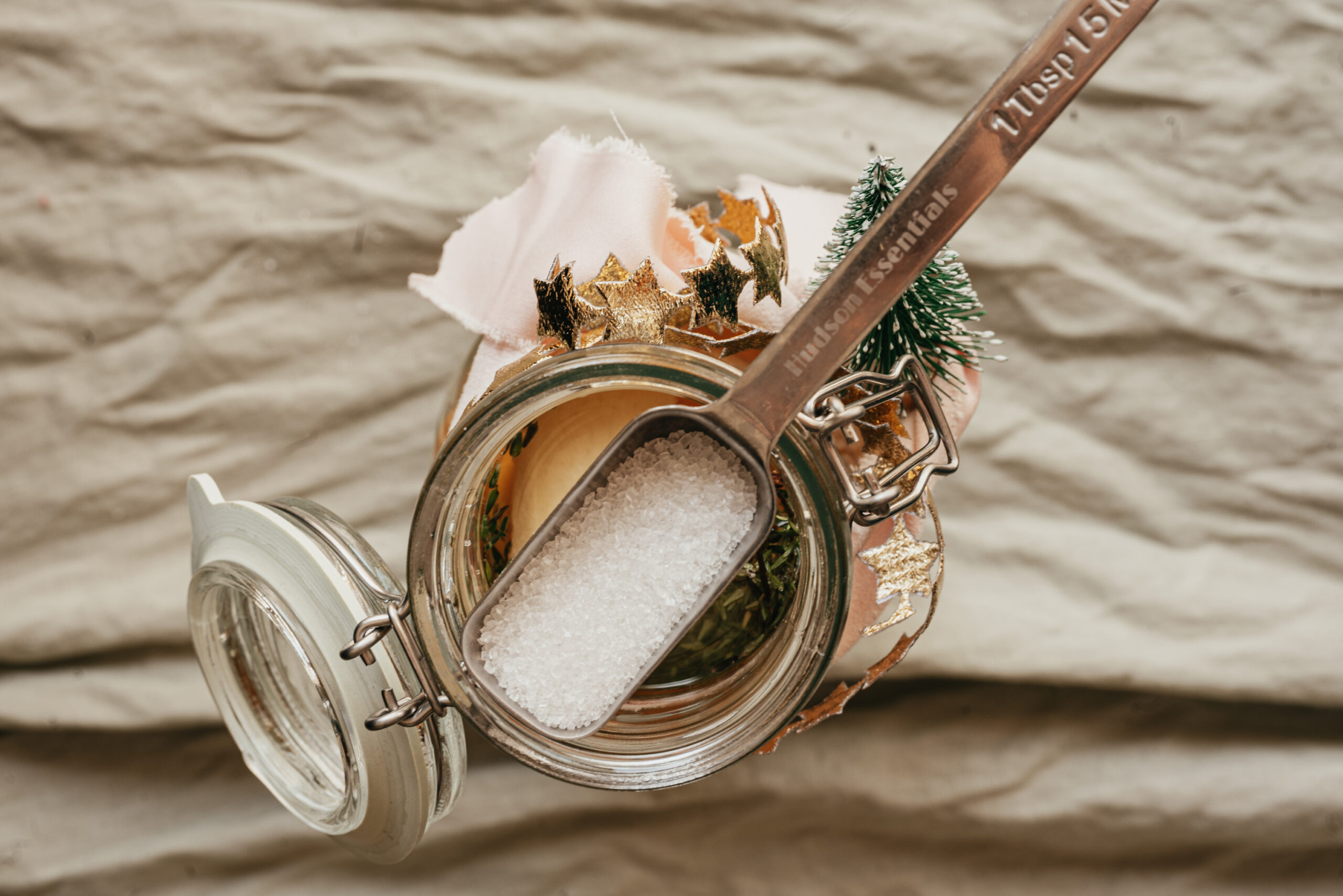 spoon of sugar resting on a jar of pine soda