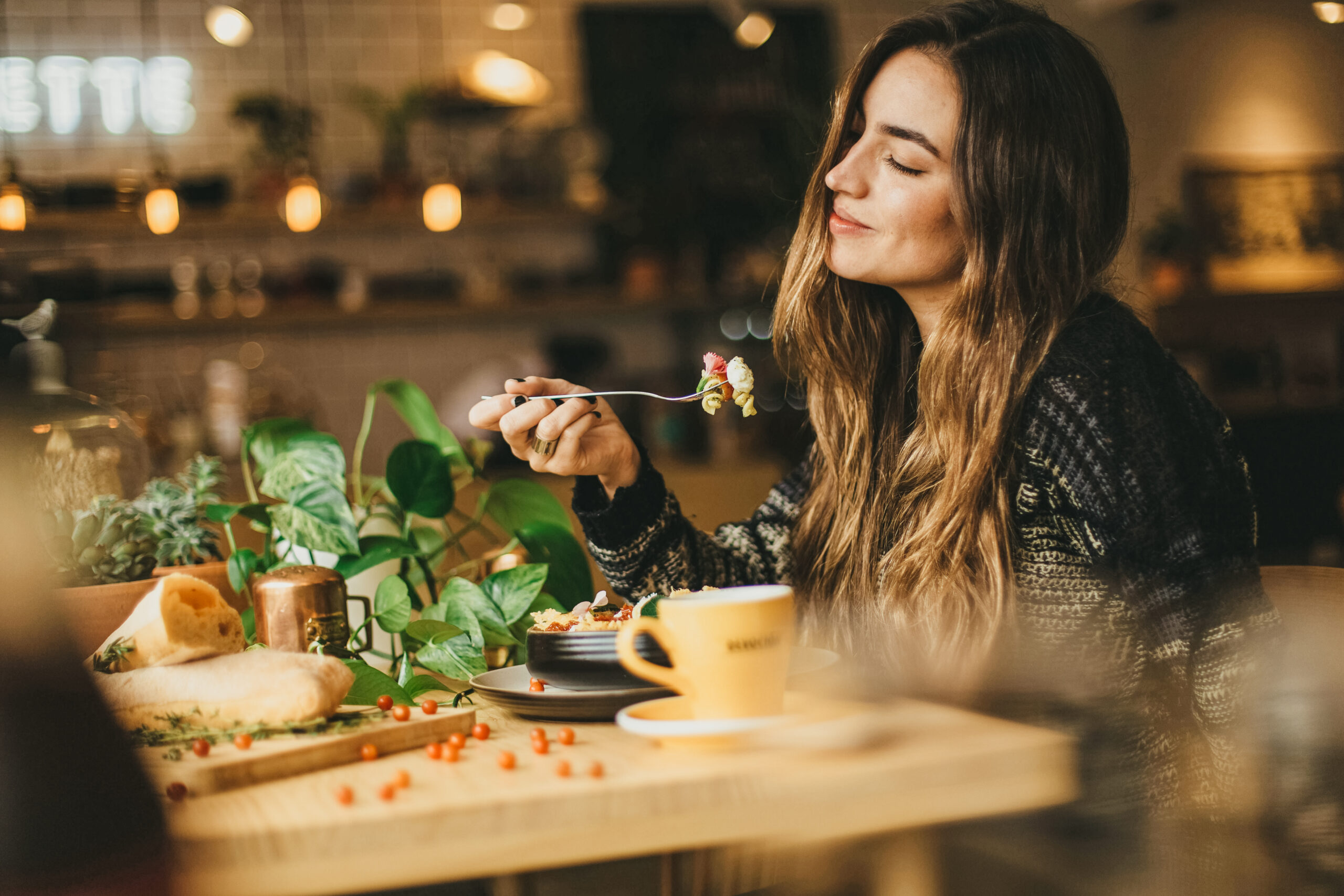 woman smiling while eating food