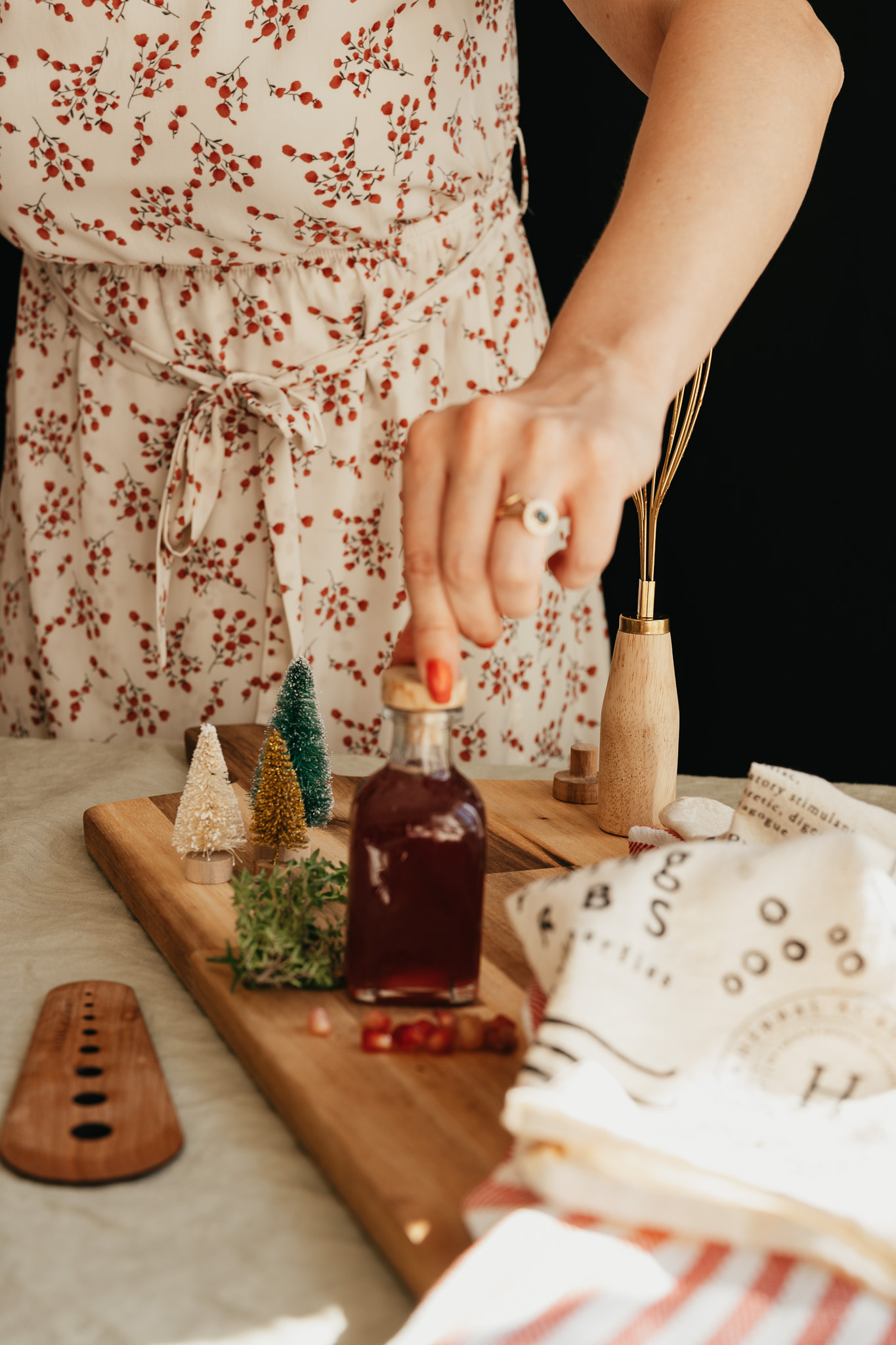 herbalist putting lid on bottle of pomegranate syrup