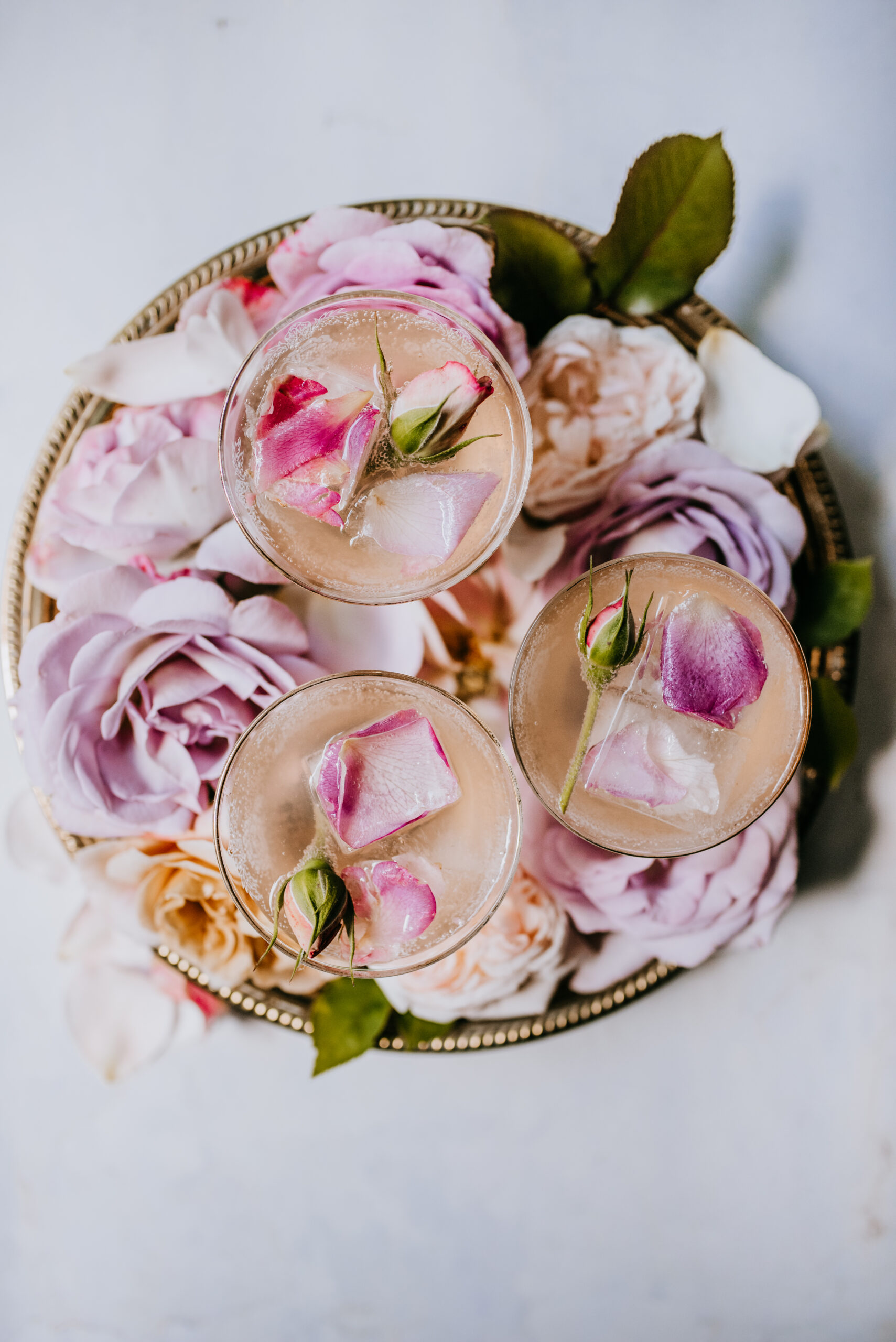 Blush Rose Gimlet cocktail in glasses and accented with roses