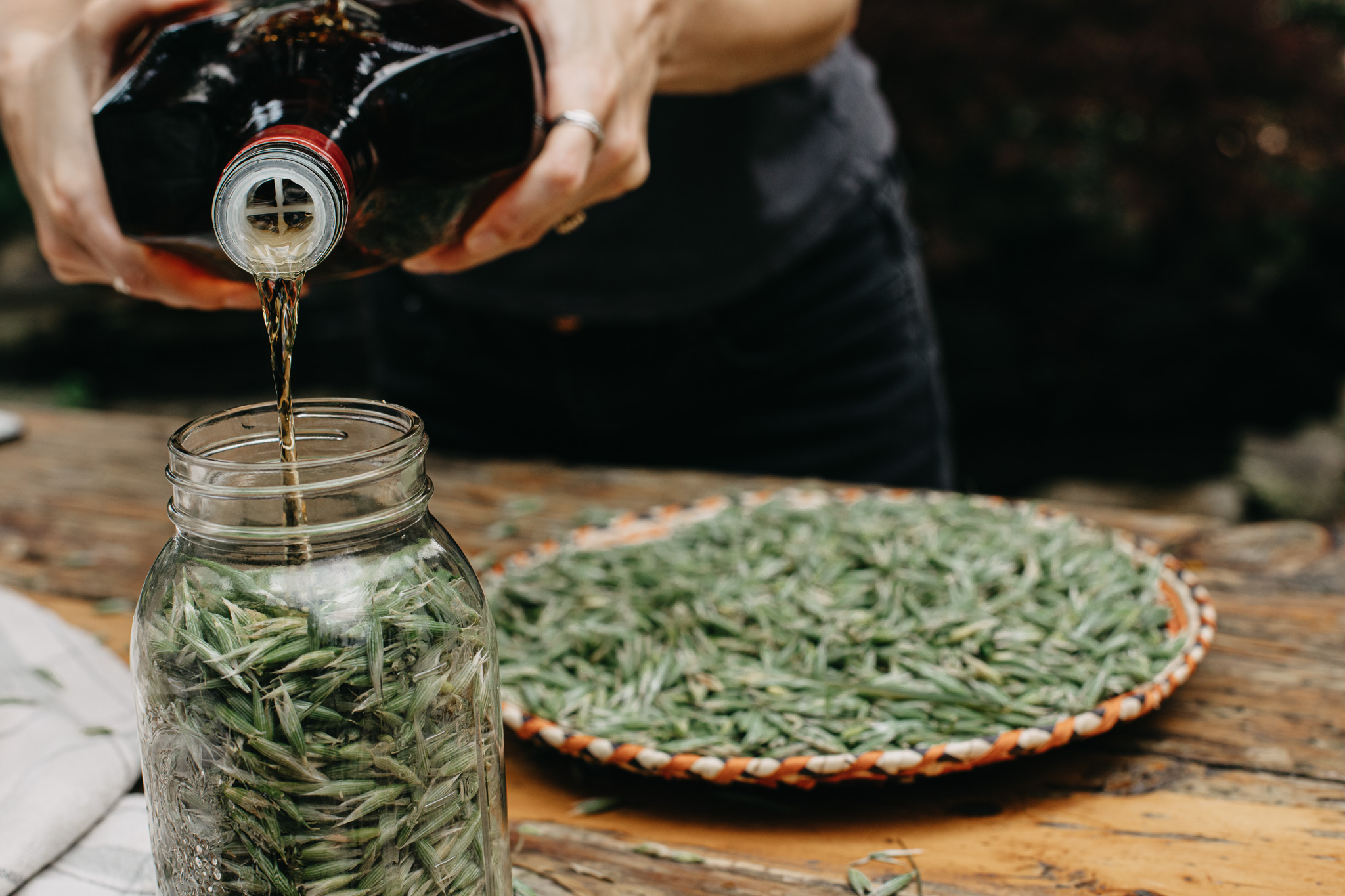 pouring oil into a jar of milky oats