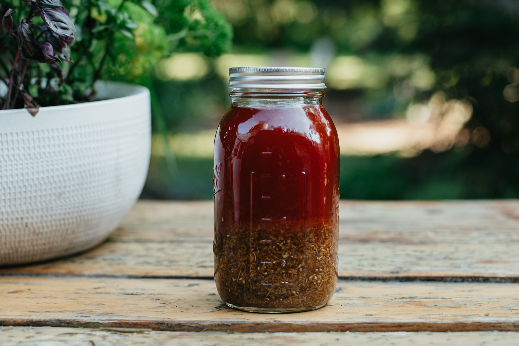 a jar of St. John's Wort Oil sitting on a table