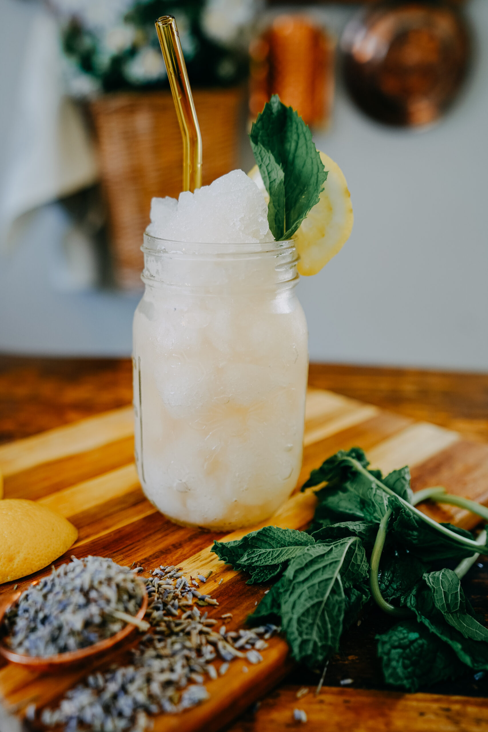 mason jar of herbal slushie sitting on a wooden board