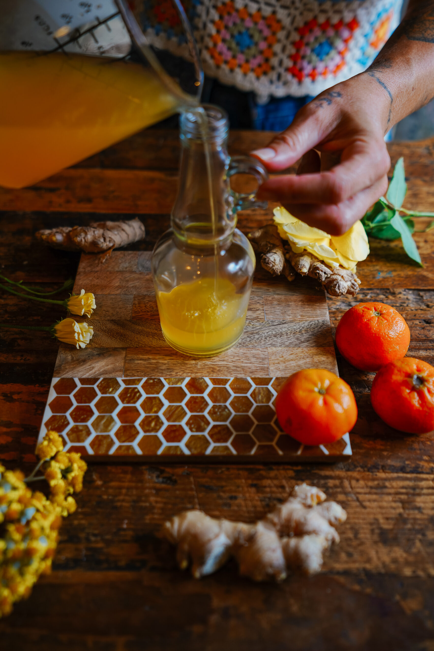 pouring mandarin ginger coridal into a bottle