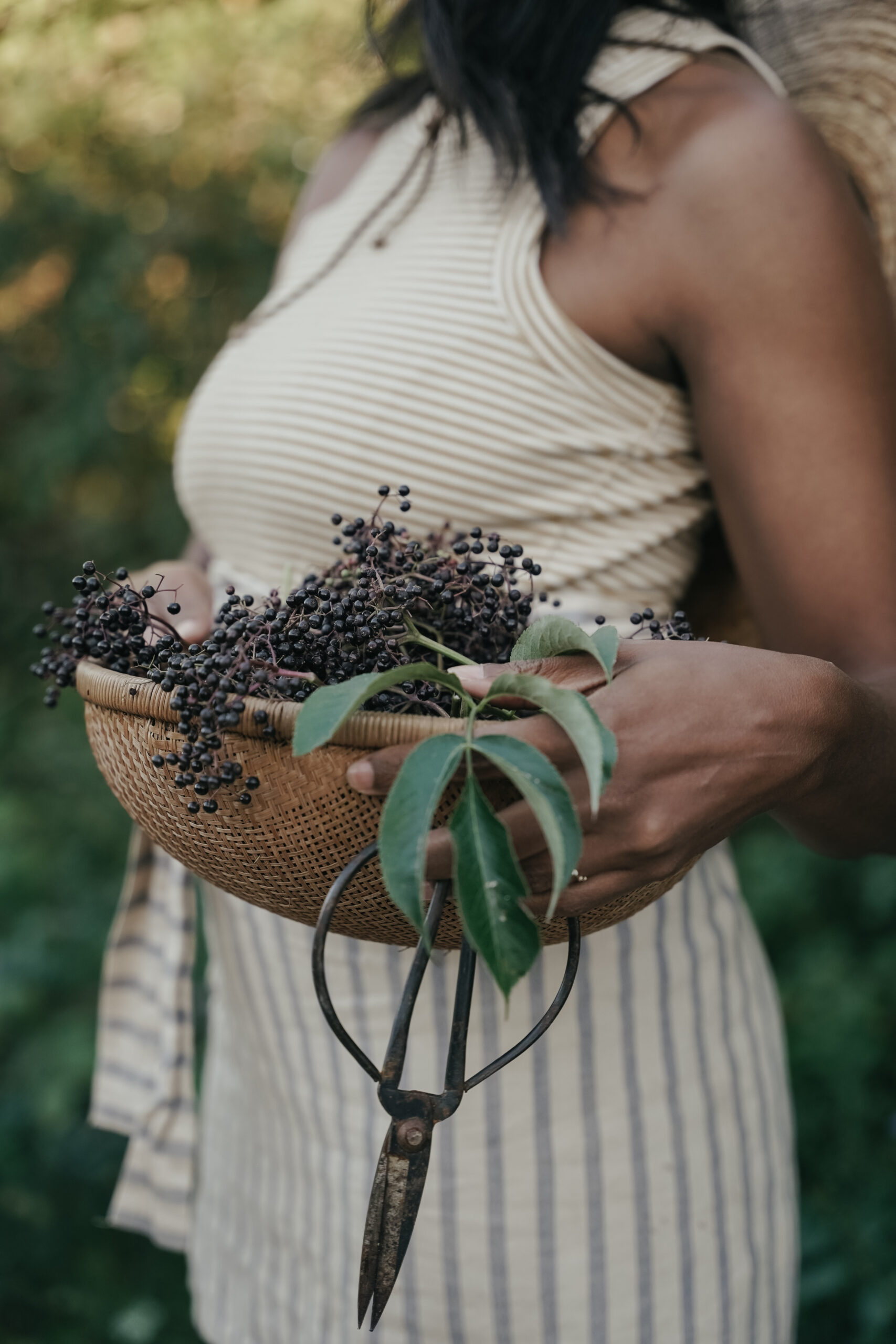 woman holding a bowl of elderberries