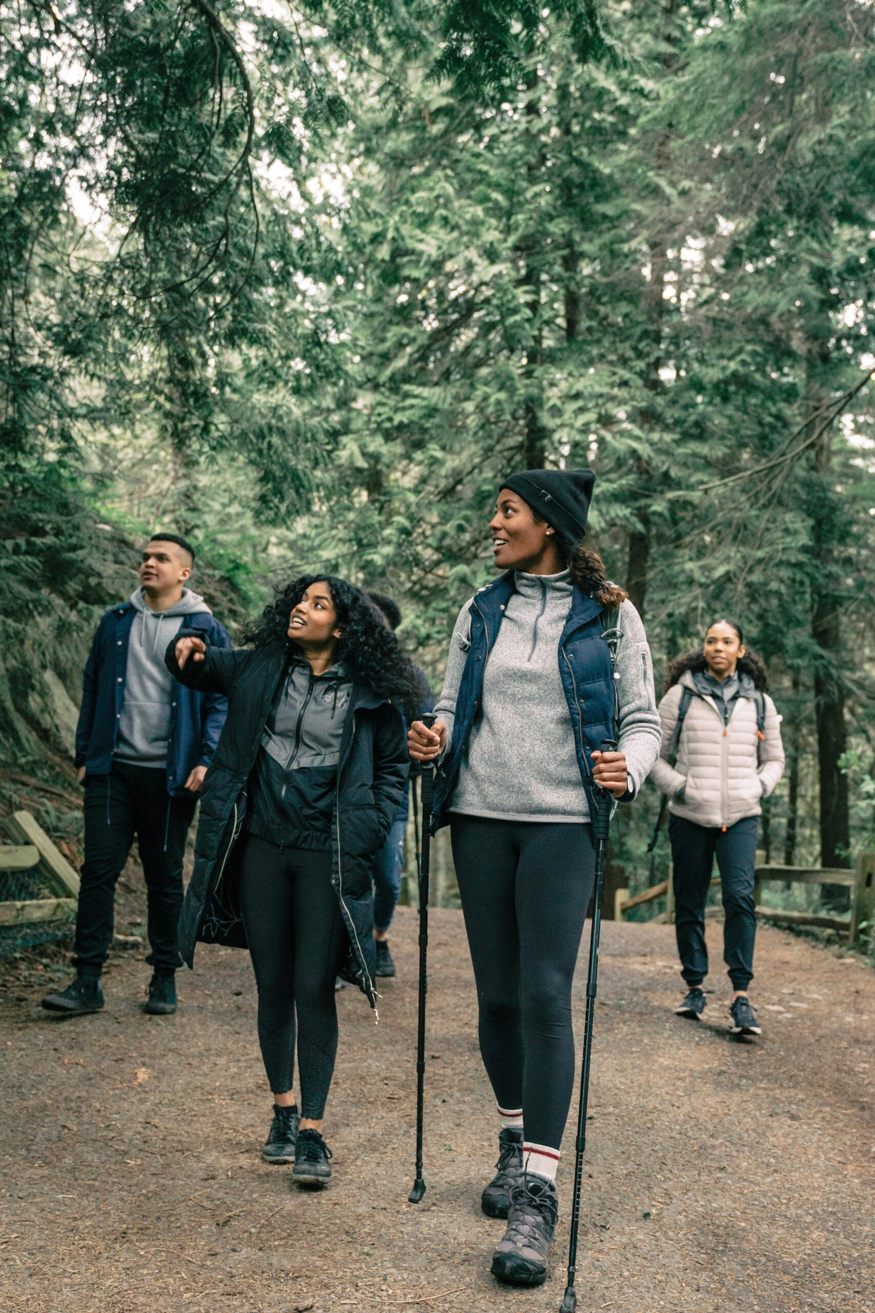 men and women hiking in the woods