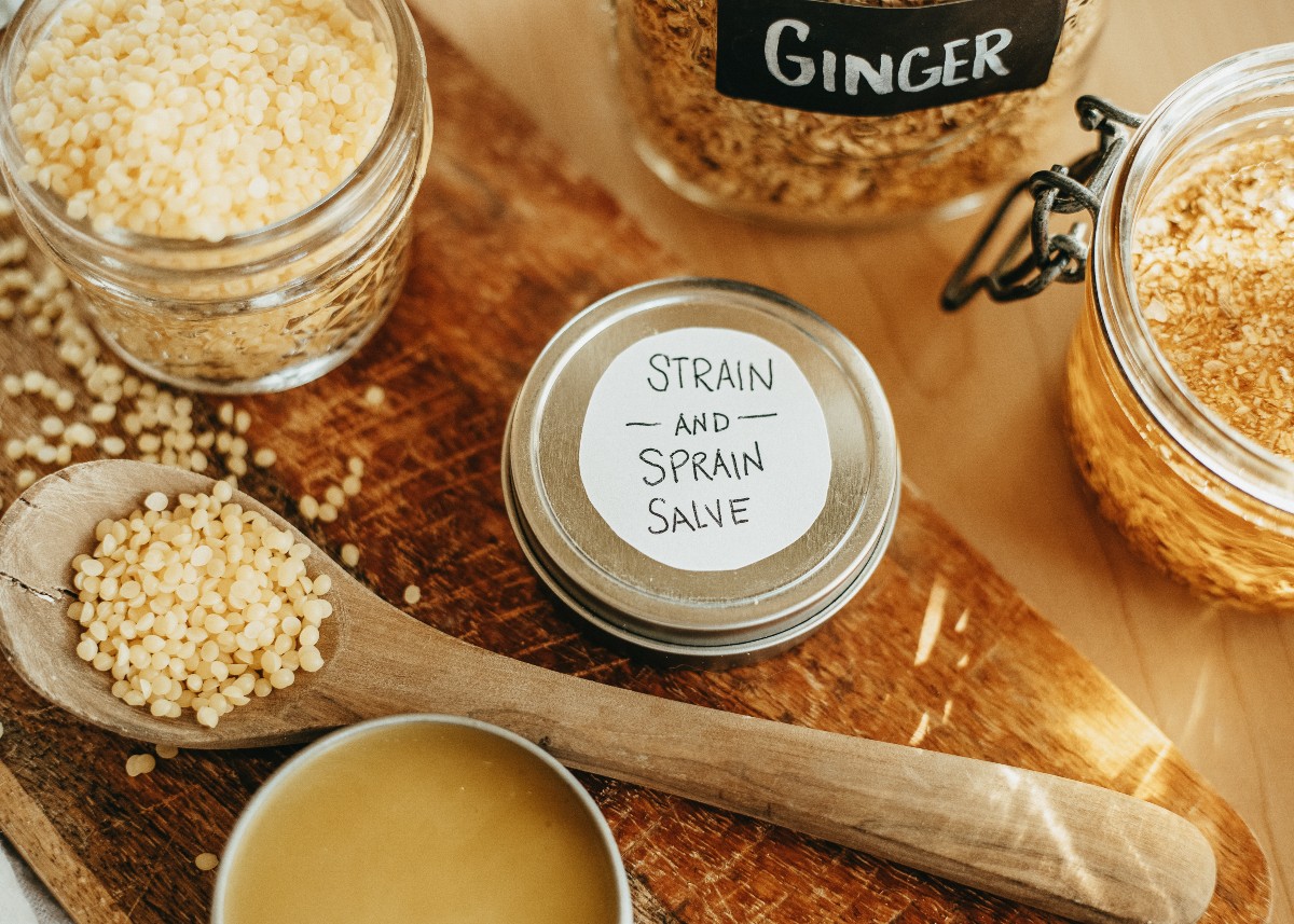 tins of salve with dried herbs in jars