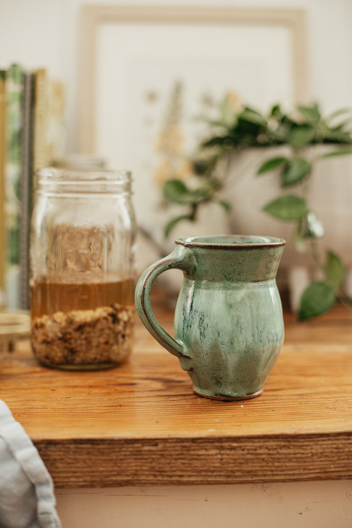 mug with jar of root tonic in the background