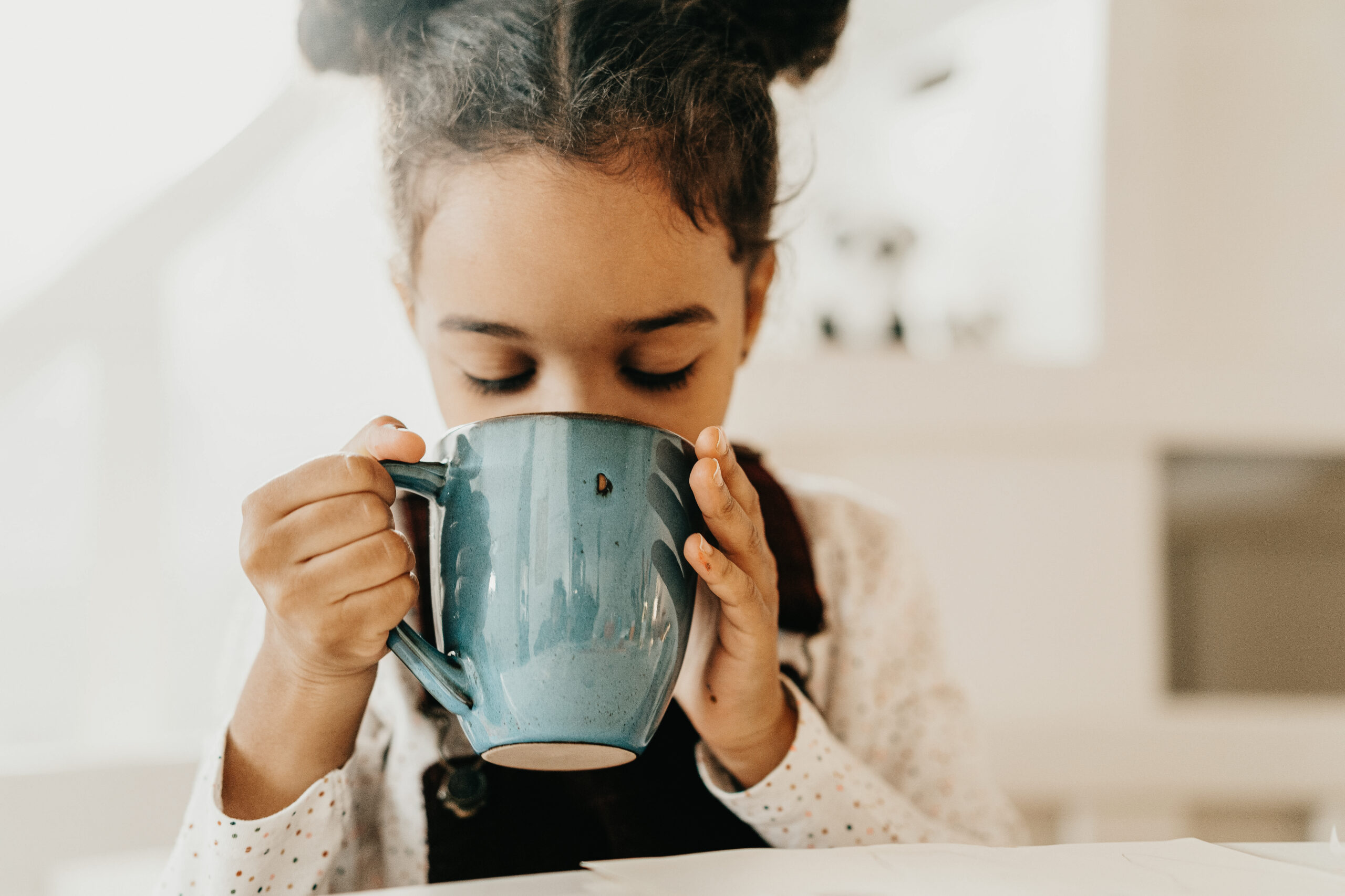 girl drinking a mug of tea