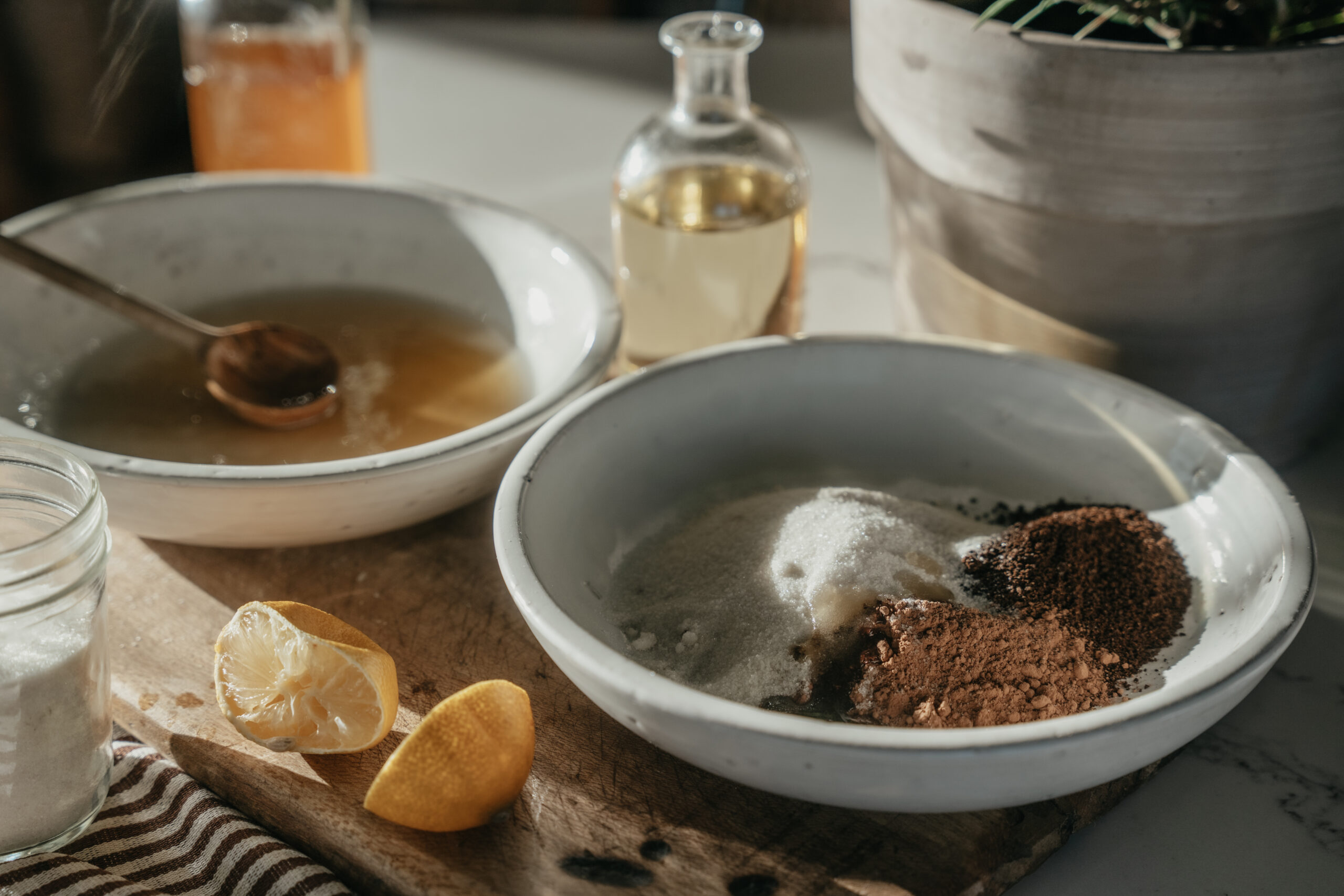 bowl of honey and bowl of herbs to make a scrub for the feet