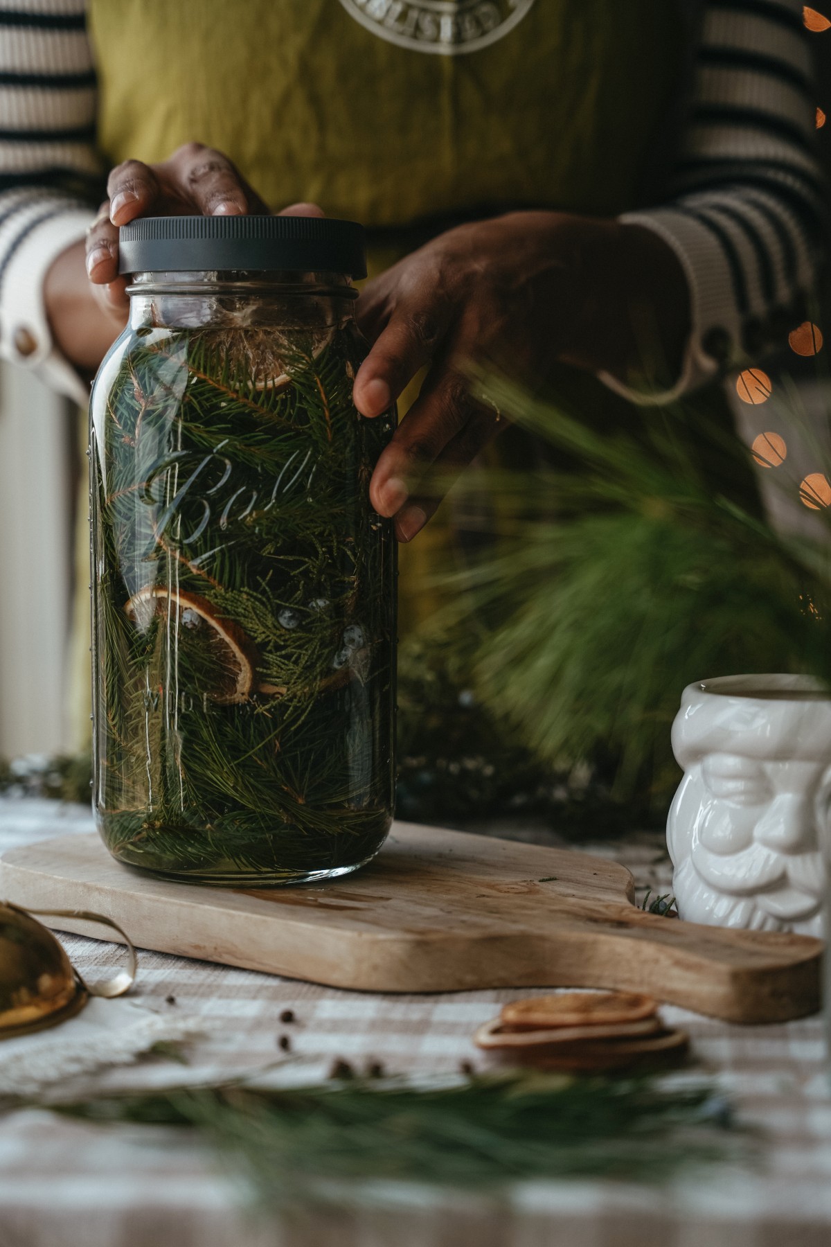 woman's hands on a jar of evergreen cleaning spray