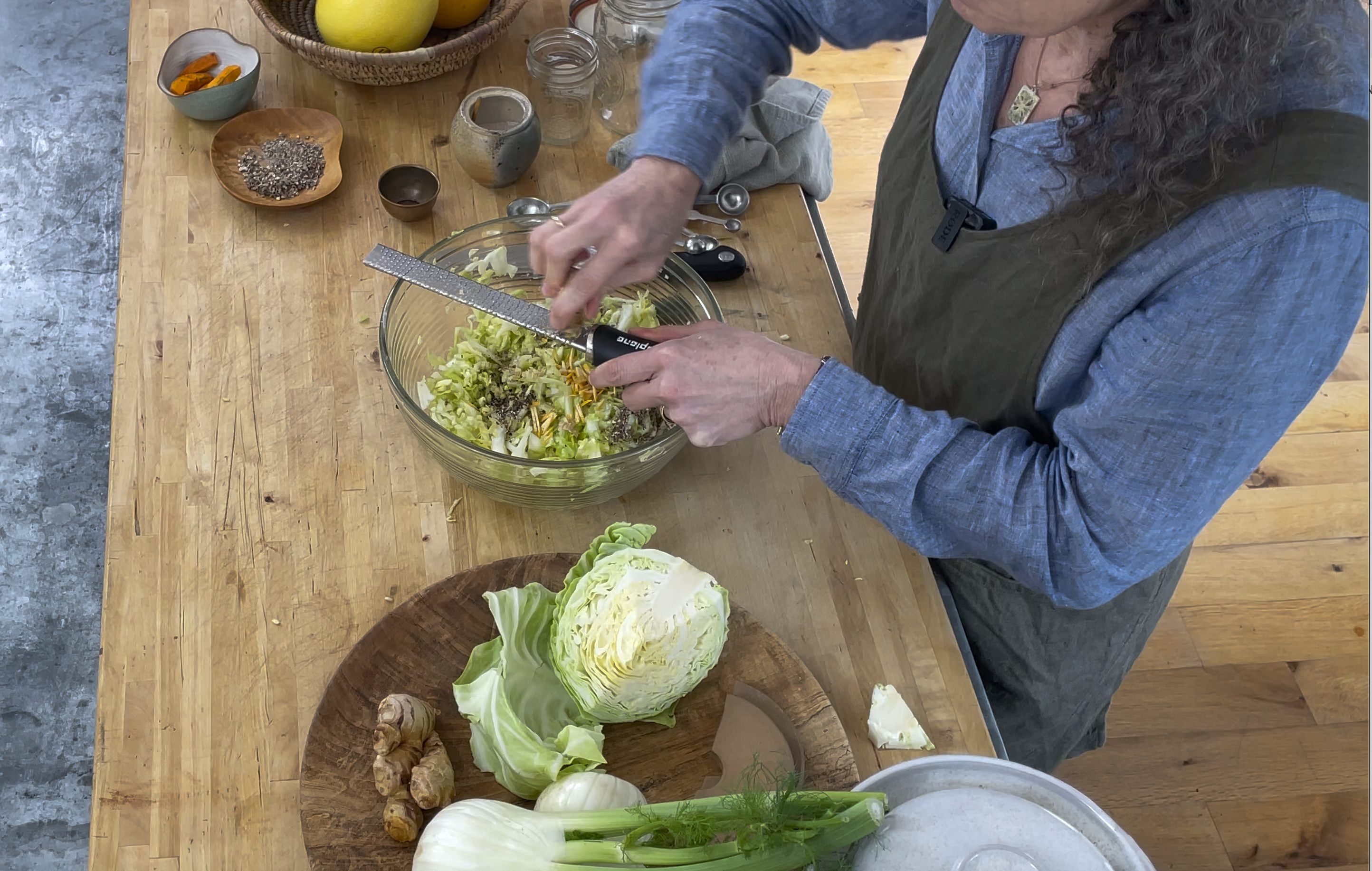 woman shredding cabbage into a bowl