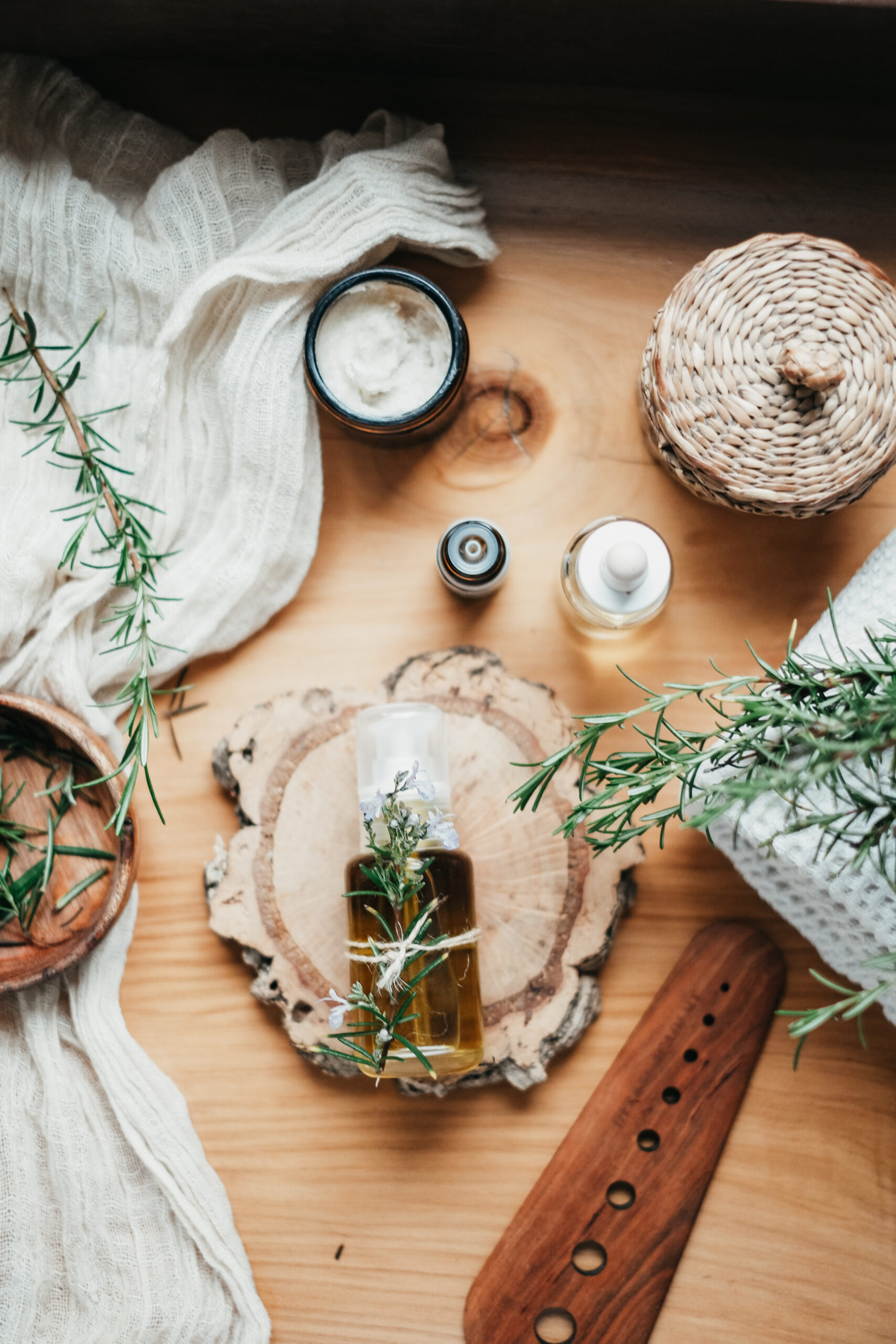 herbal hair oil in a bottle lying on a wood slab