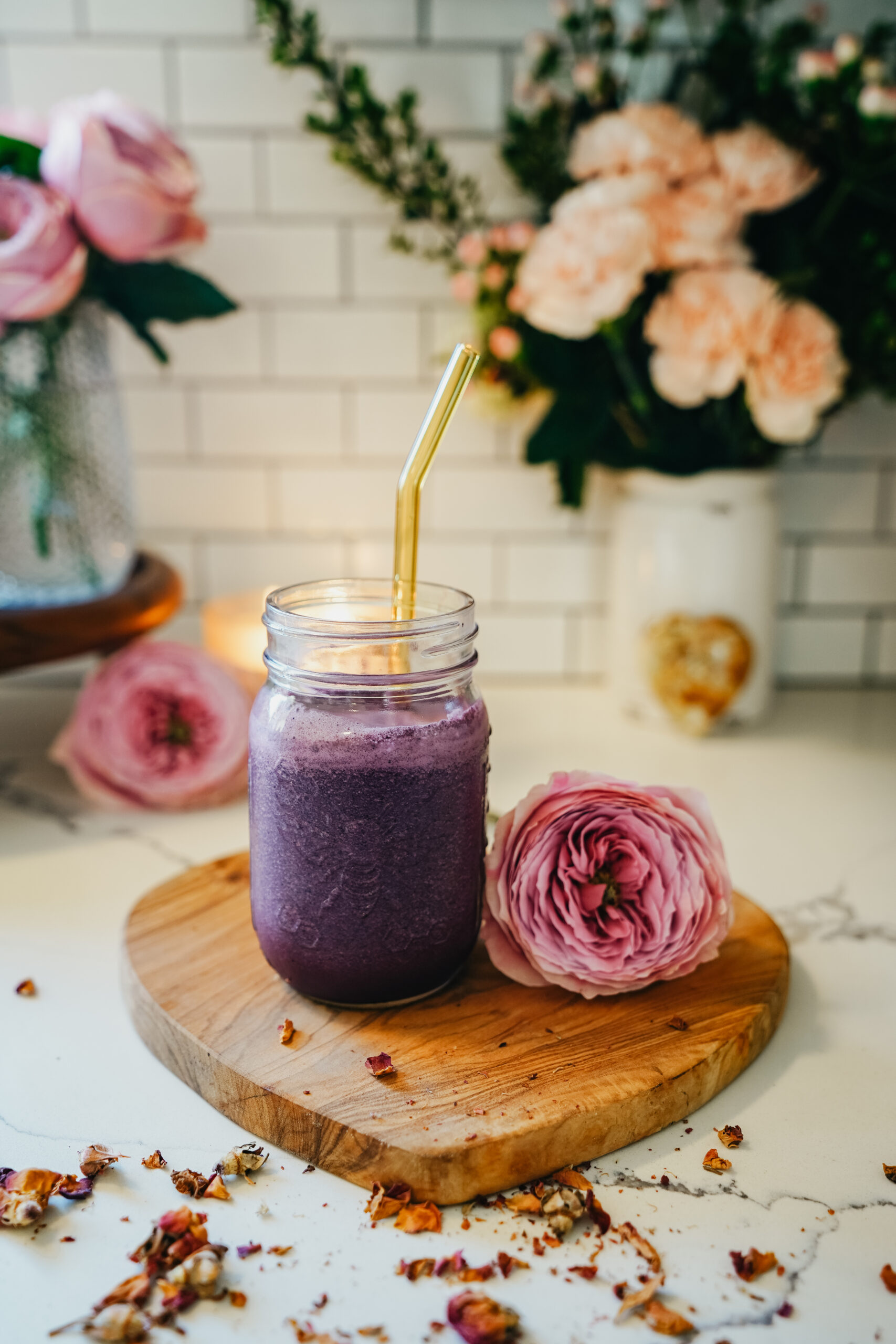 chocolate rose smoothie in a jar with a rose next to it on a heart shaped cutting board