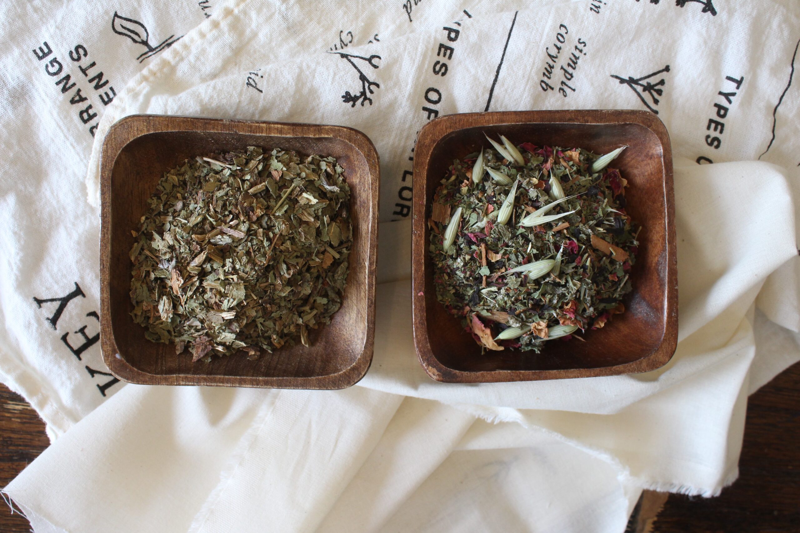 two bowls of herbs on a table