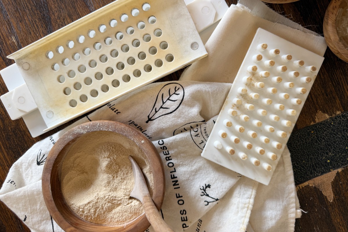 capsule machine with a bowl of powdered herb