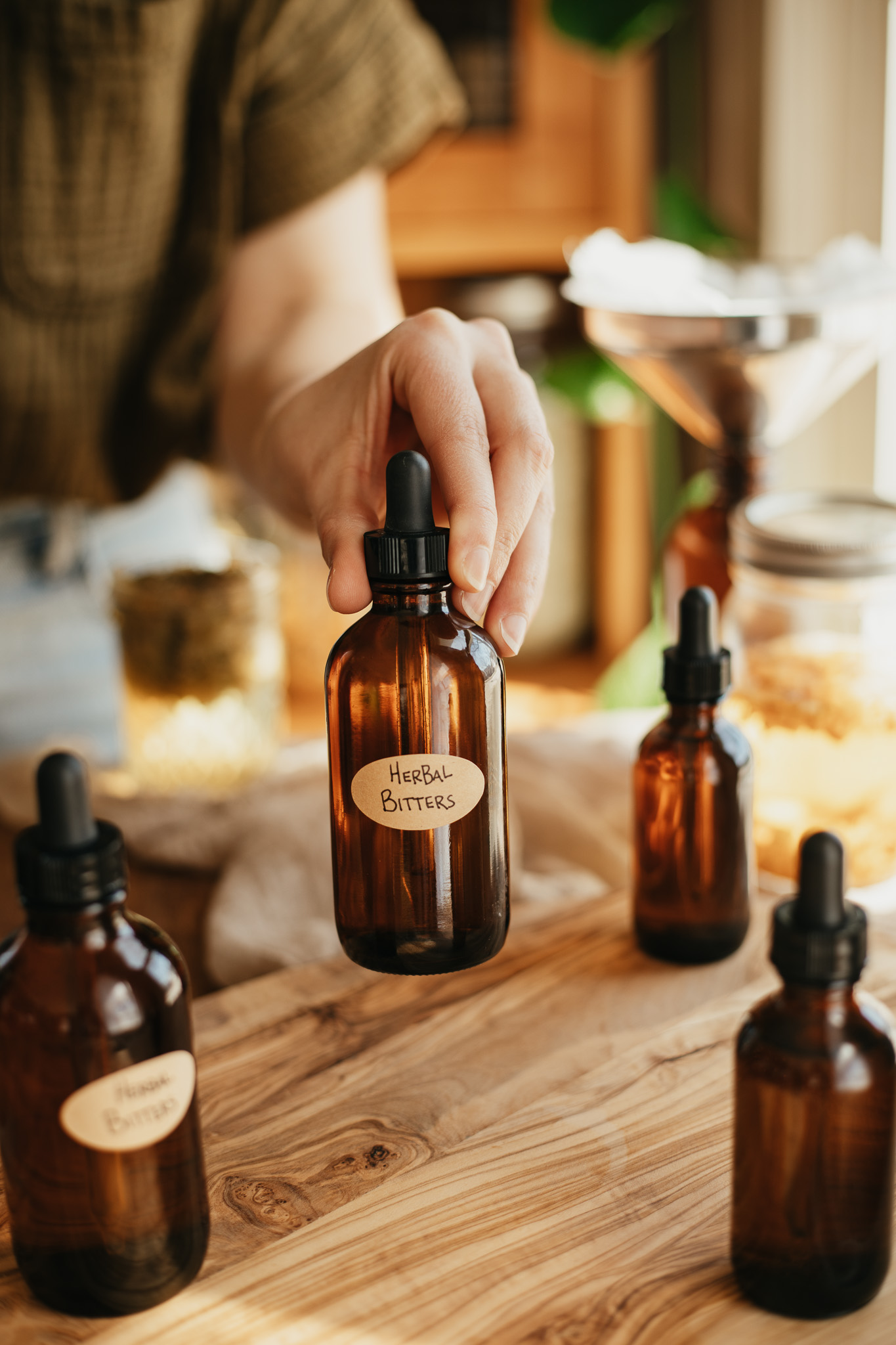 hand holding a tincture bottle of herbal bitters