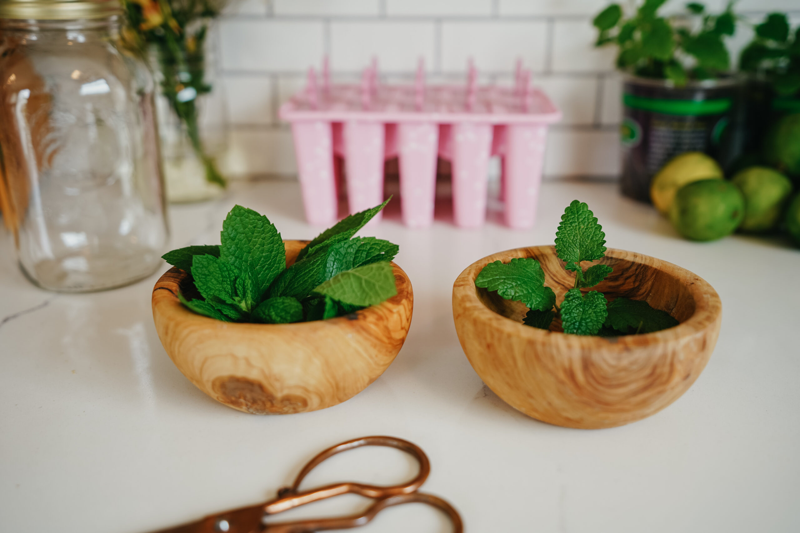 2 small wooden bowls filled with fresh herbs