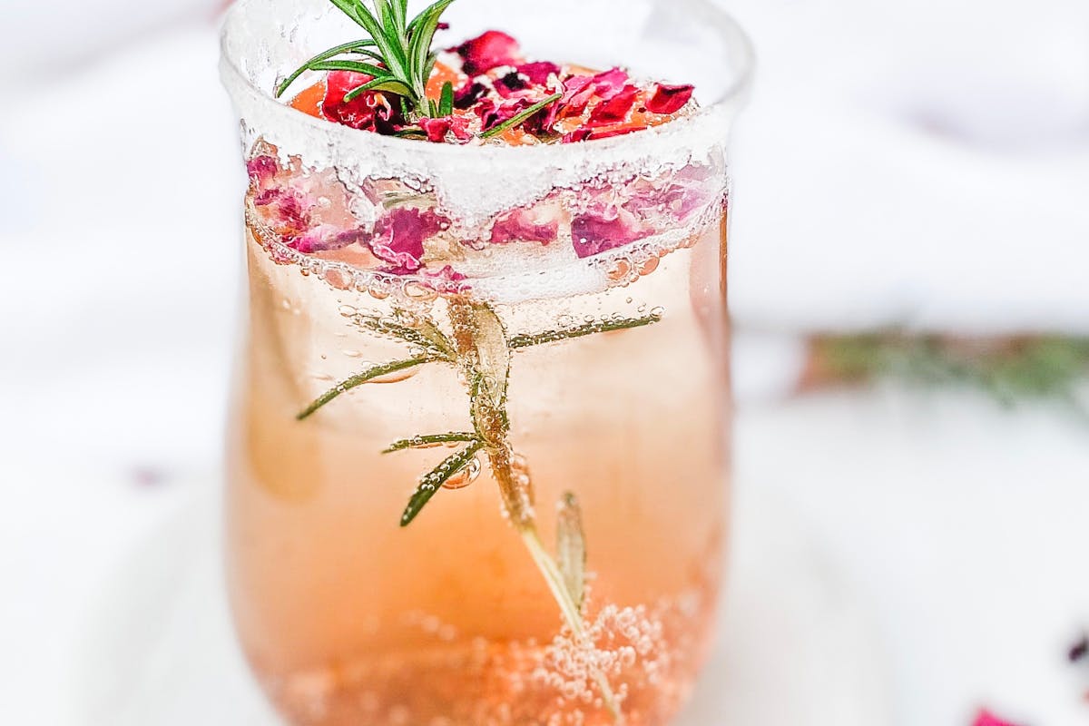 refreshing drink with leaves and flower petals