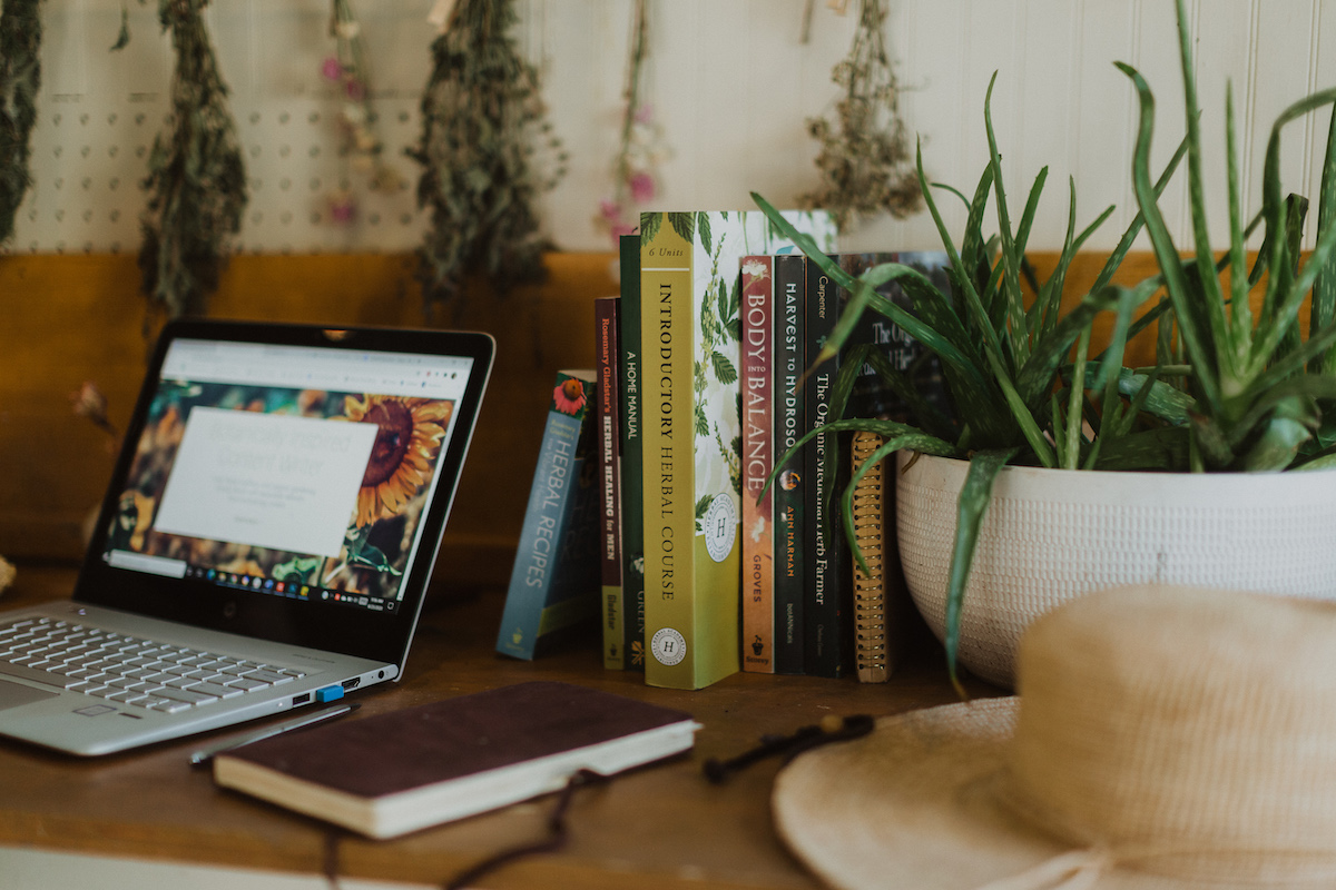 Herb books next to a laptop