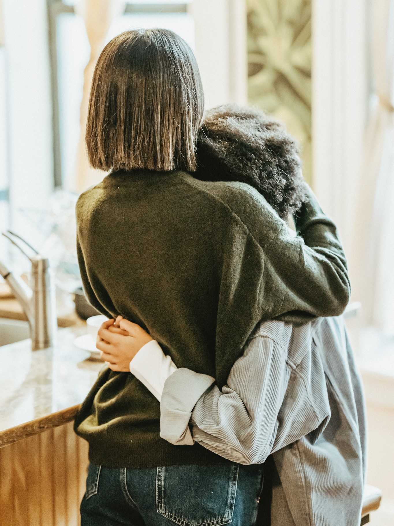 A woman and young child hugging, representing the struggles of dealing with a tick-borne disease, as discussed in Herbal Academy's Holistic Approach for Tick-Borne Diseases Course. 