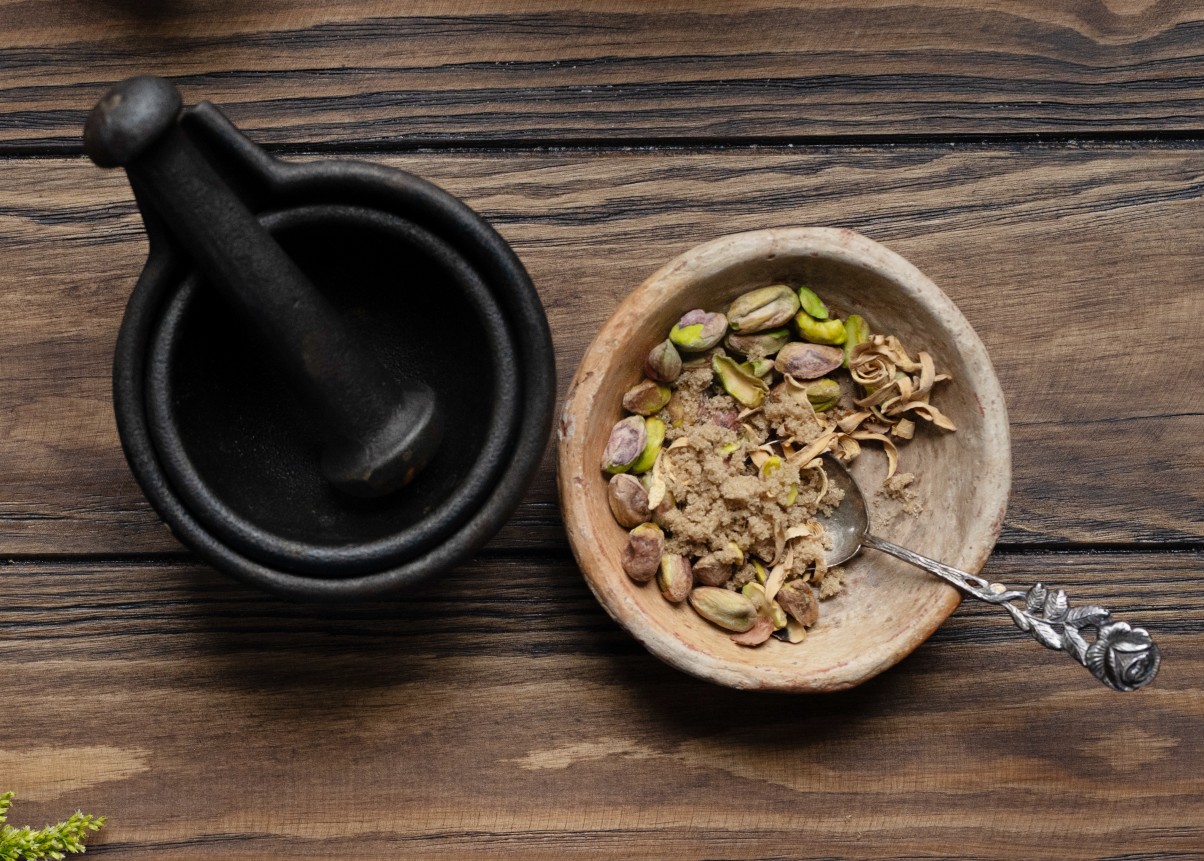 mortar and pestle and a wood bowl with herbs for orange blossom latte