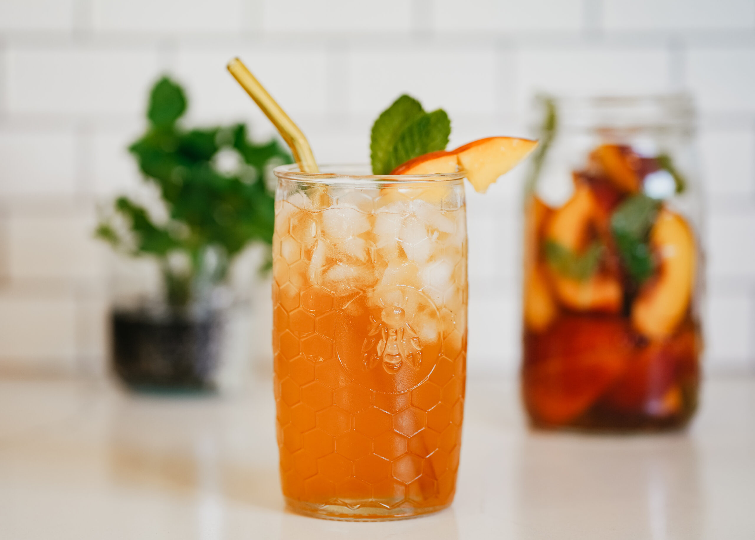 glass of peppy peach tea on a table