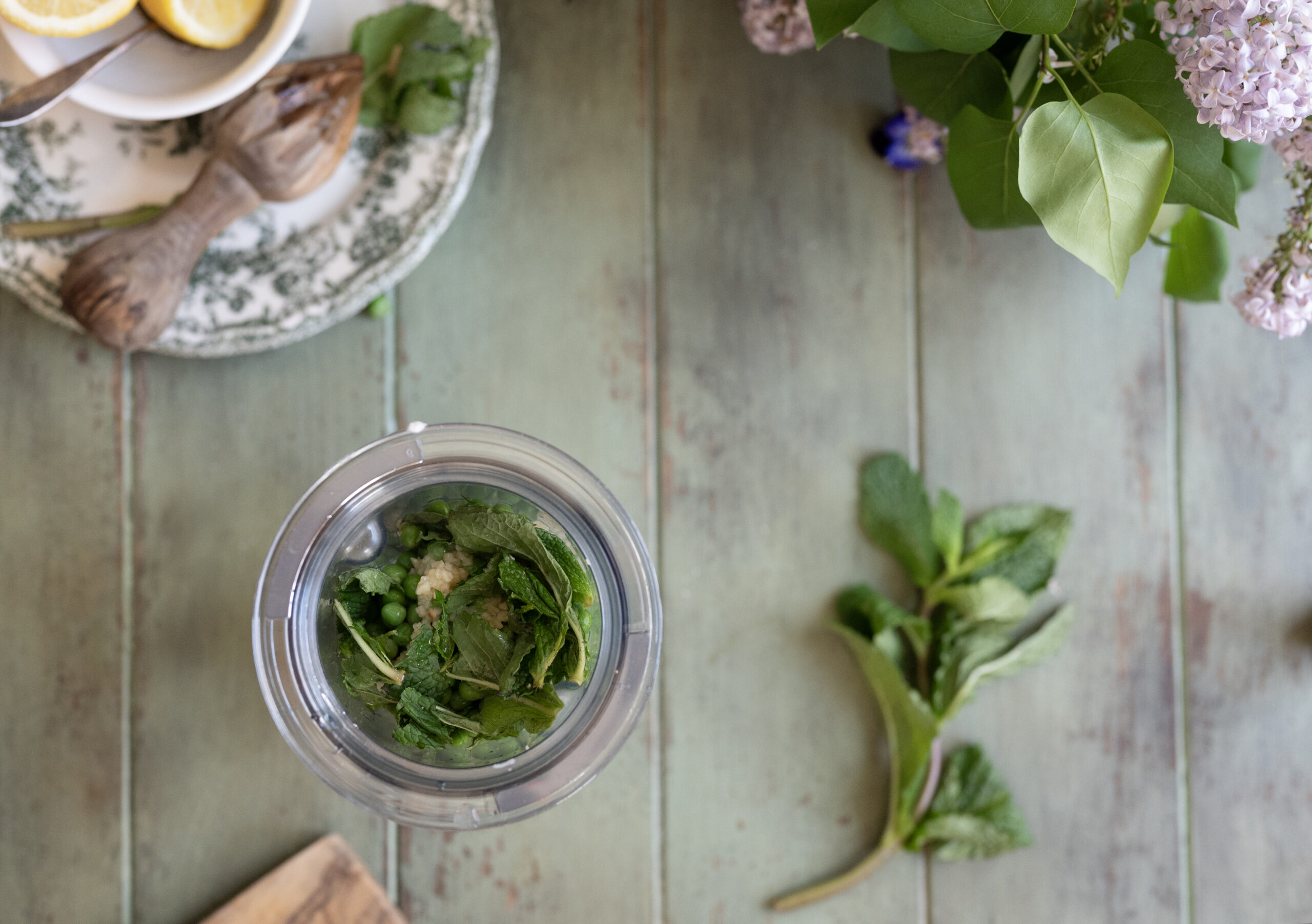 jar of mint and peas with flowers and mint in the background