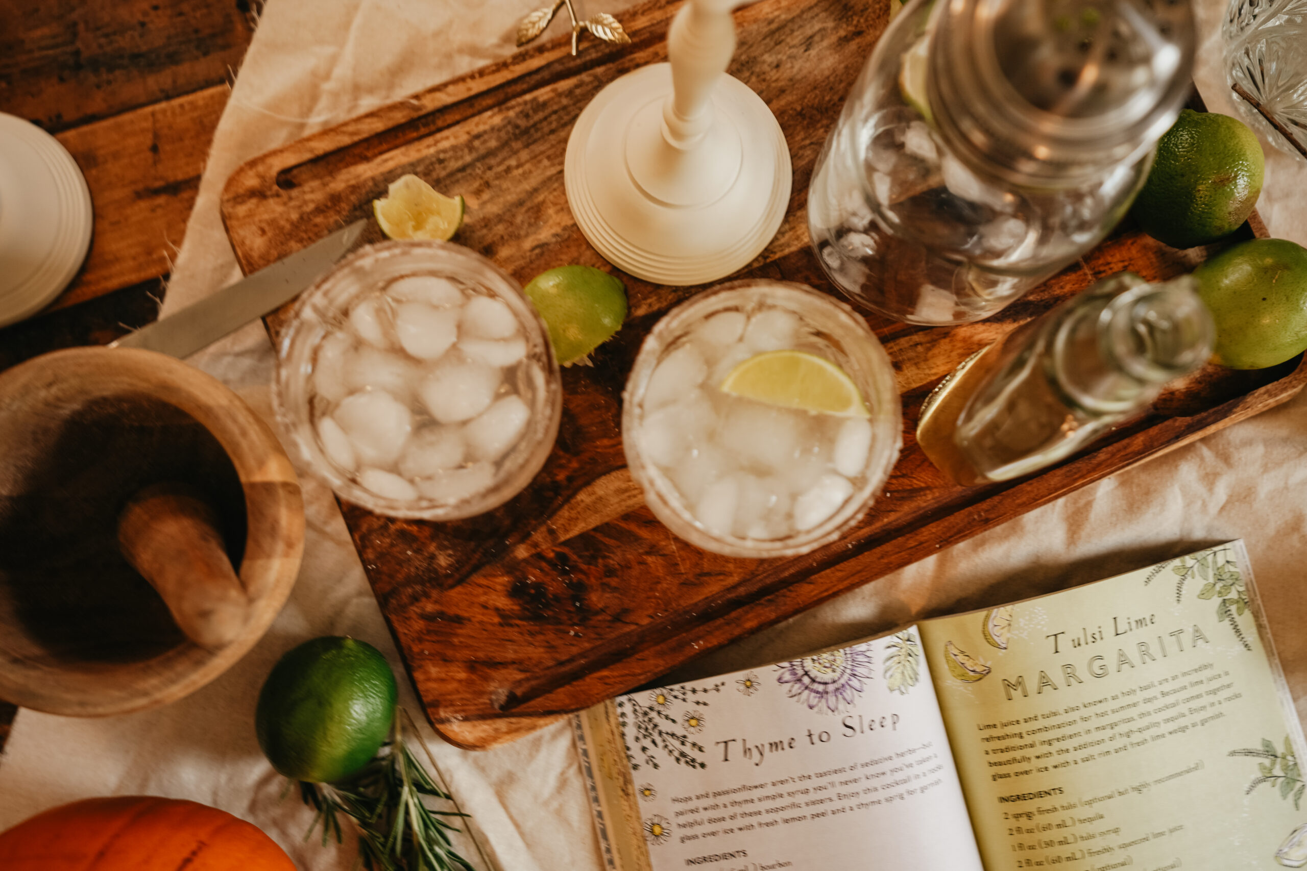 aerial view of glasses of margarita with an open book showing the recipe