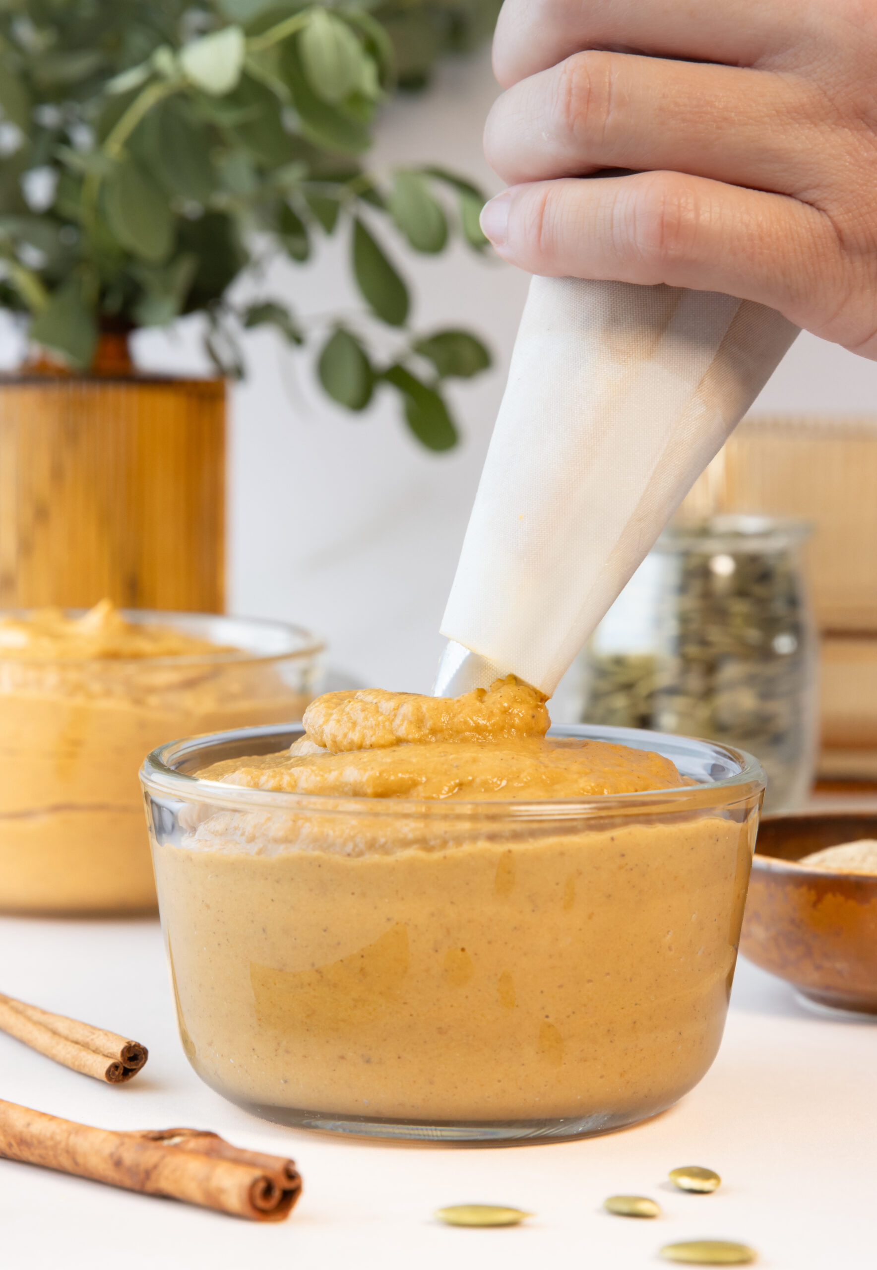 piping pumpkin pie pudding into a bowl